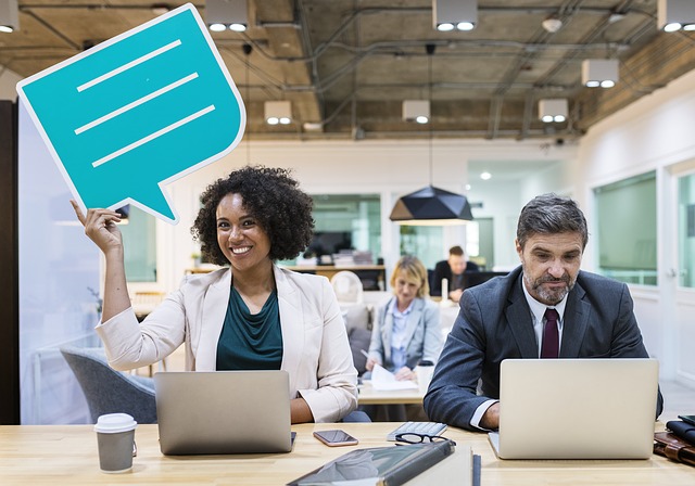 woman in business clothes holding a speech bubble cut out