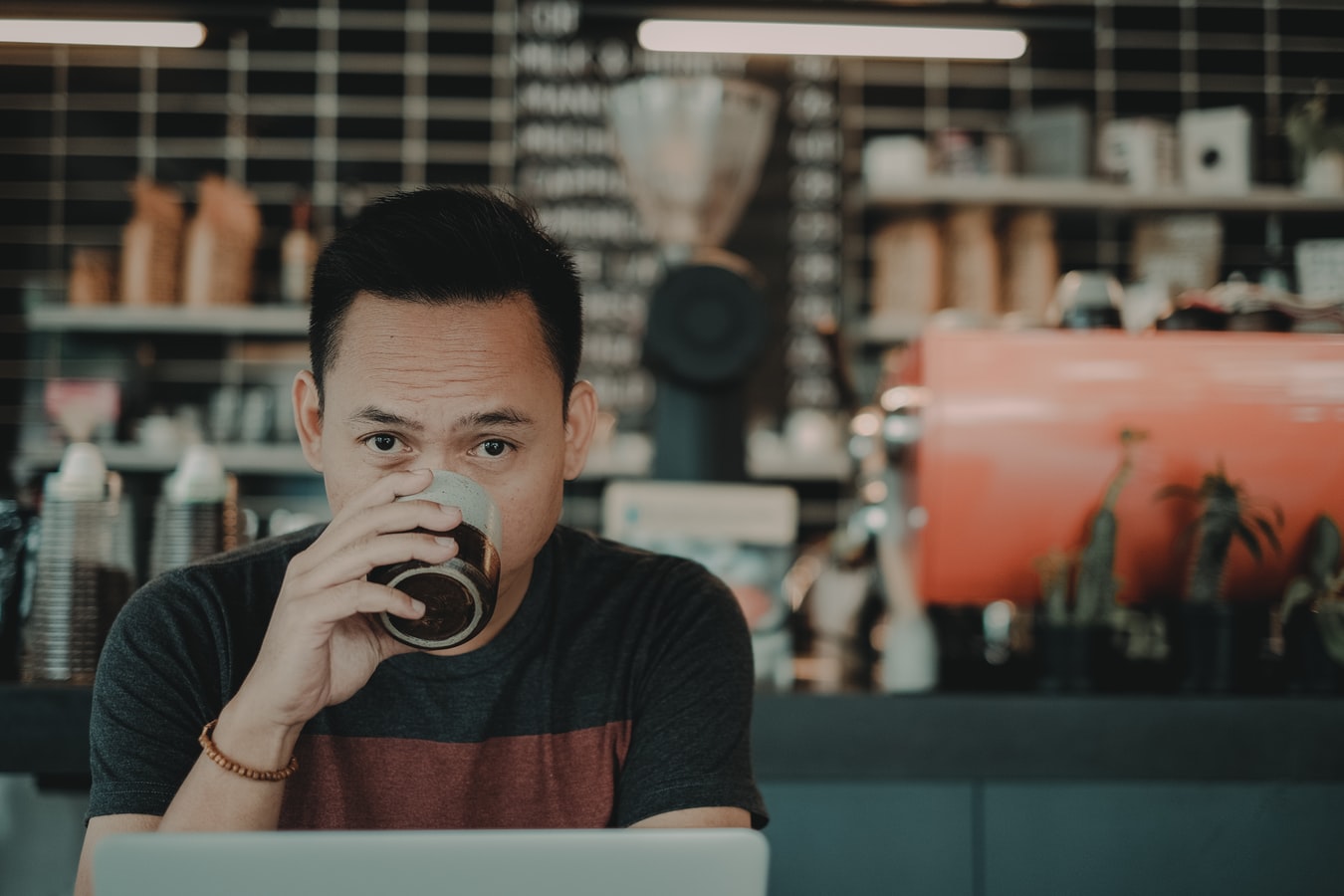 Man sitting in a coffee shop drinking coffee