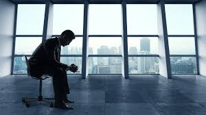 business man sitting in a chair in an office alone